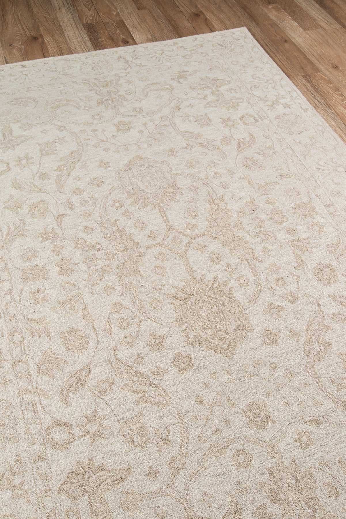 Cream beige oriental rug with subtle floral medallions and vines on a wooden floor.
