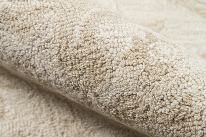 Beige plush boucle rug with soft looped pile; cozy textured carpet close-up.