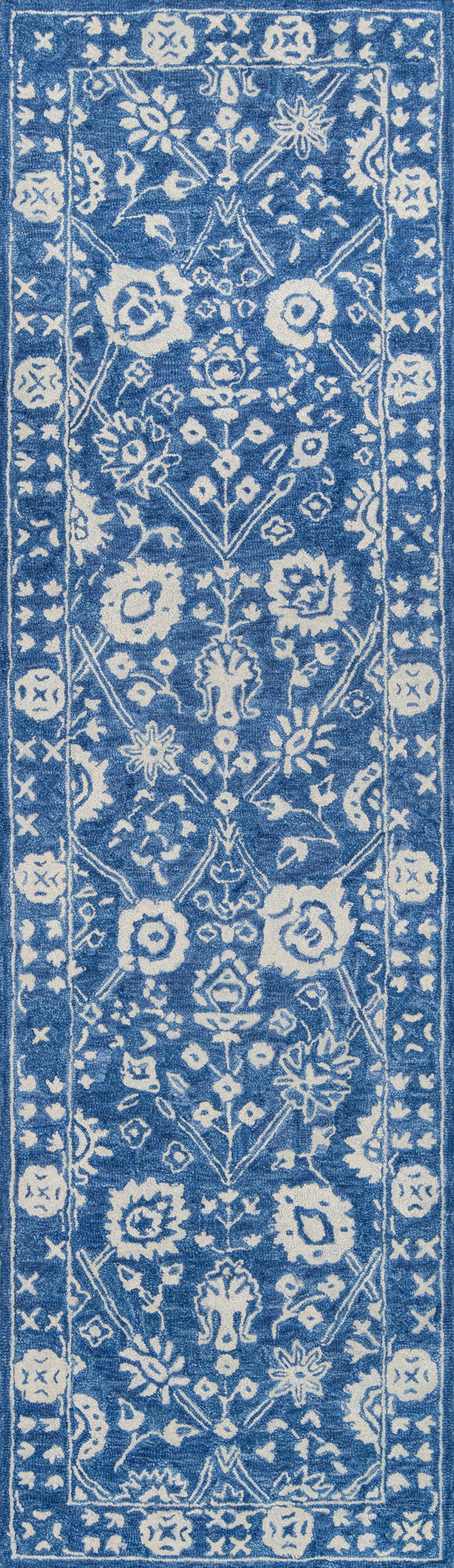 Rectangular blue rug with white floral vine motifs and ornate border in traditional oriental style.