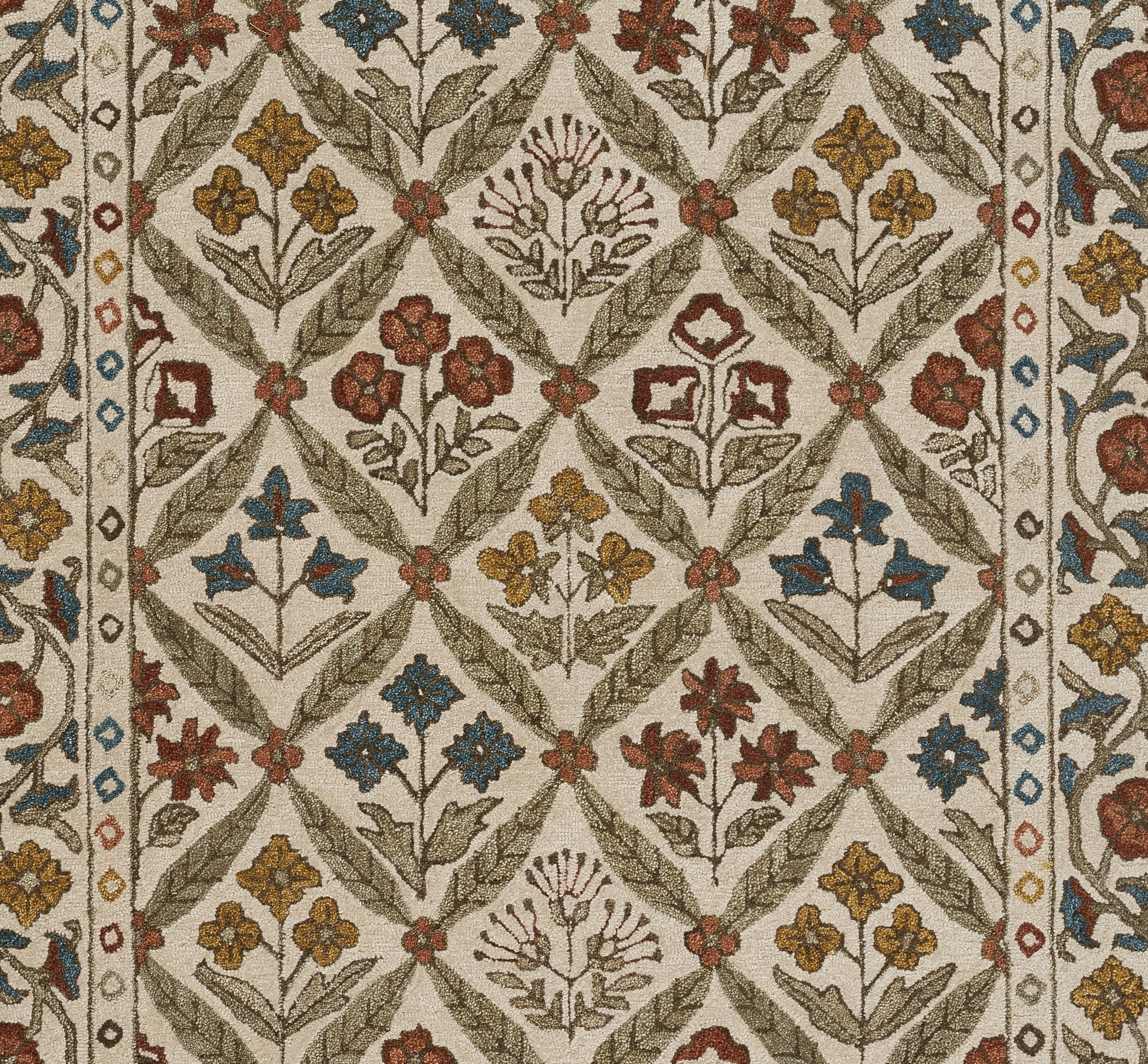Beige rug with interlocking diamond lattice and multicolored floral motifs in red, blue, yellow, and olive.
