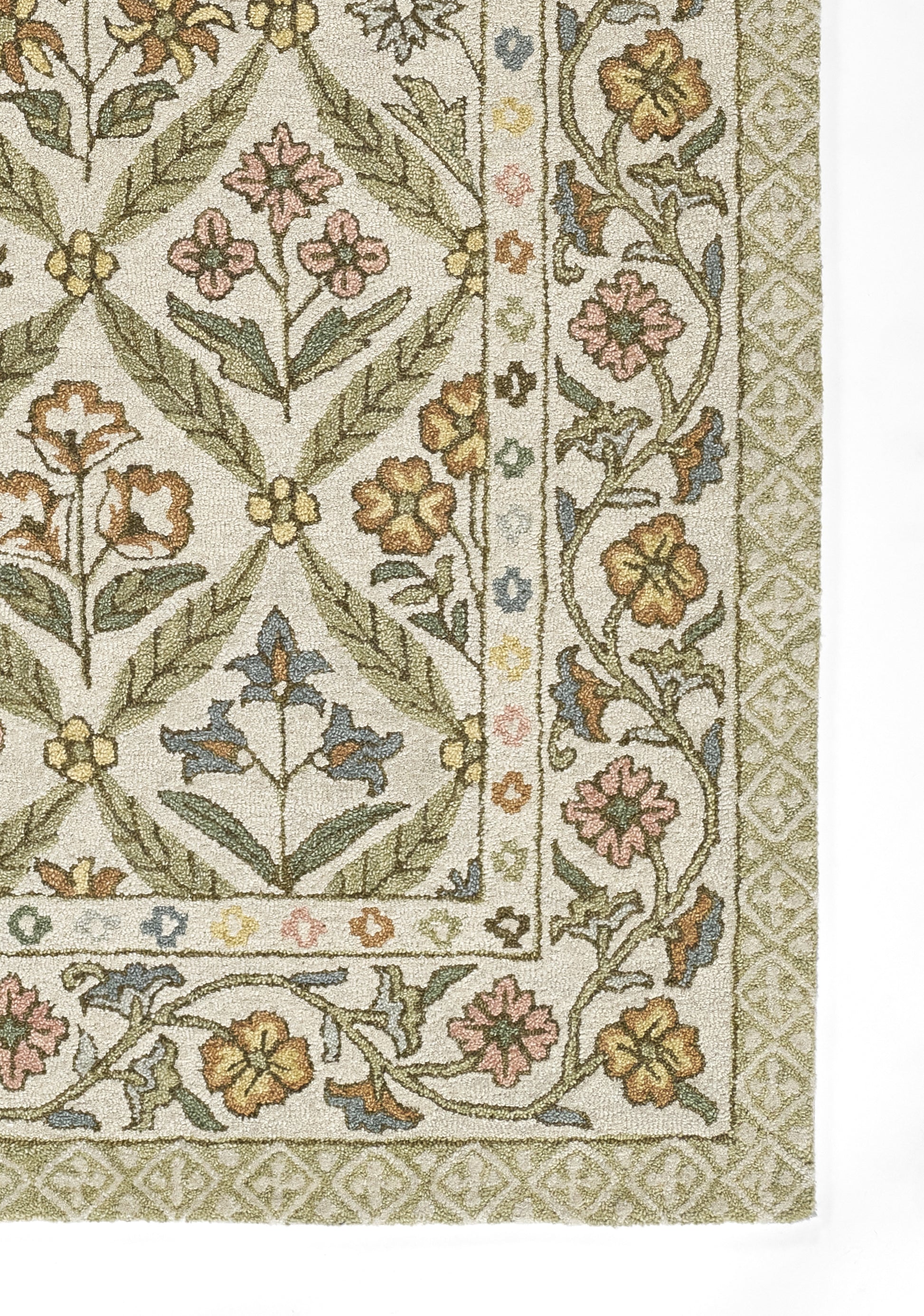 Cream rug with green leafy floral trellis, pink and blue blossoms, and a pale geometric border.