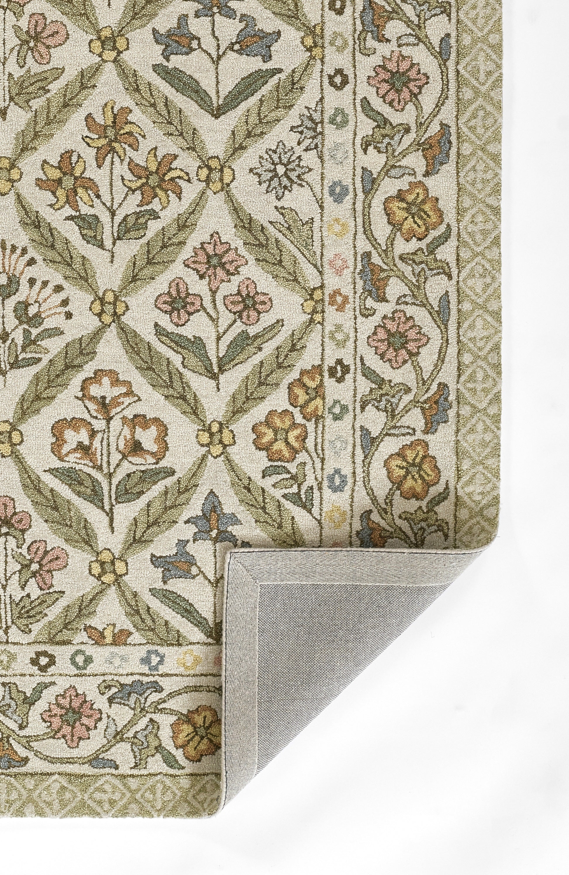 Green, cream floral patterned rug with border, woven texture; ivory background, folded corner reveals gray backing.