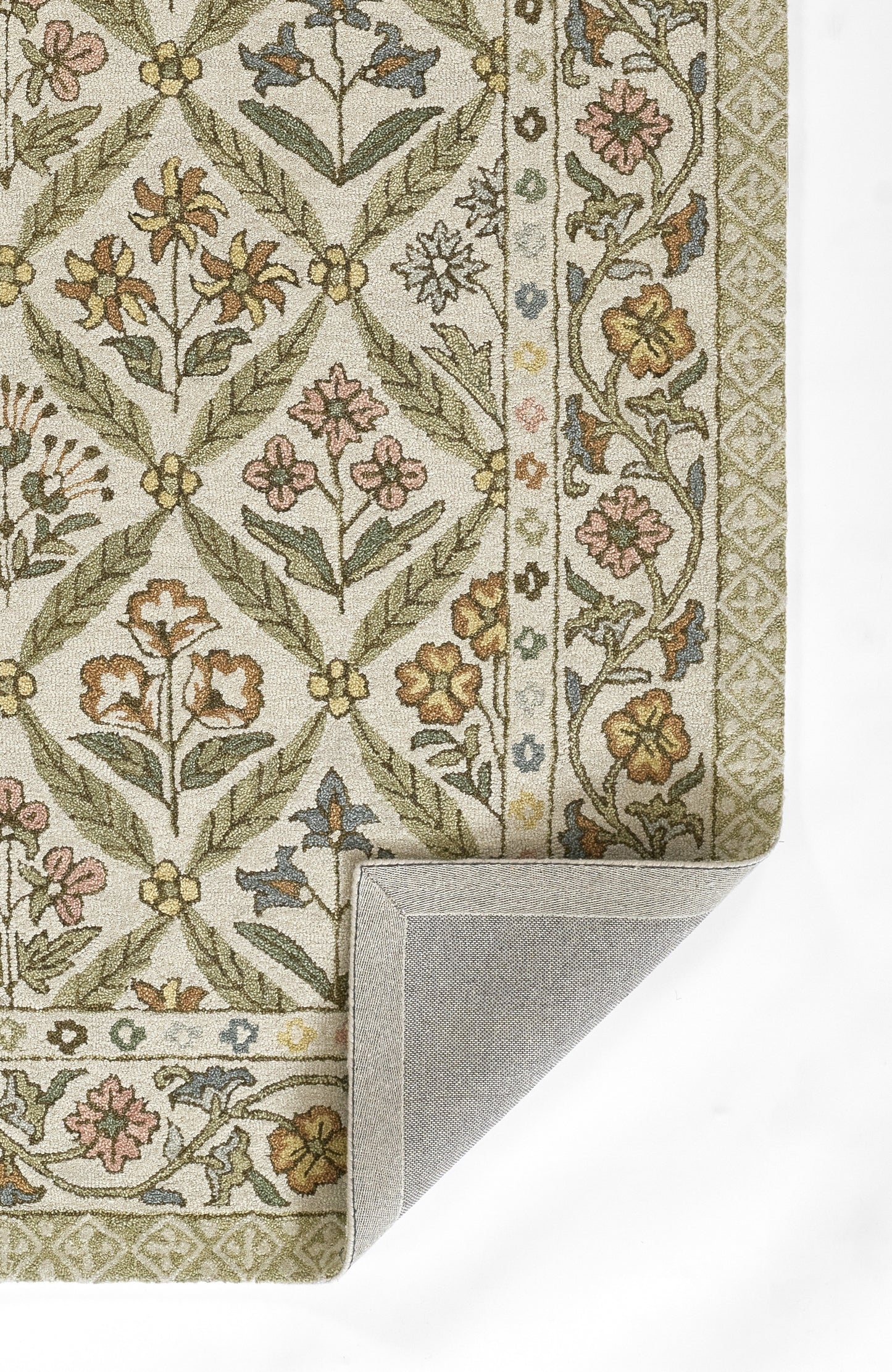 Floral area rug with green vines & pink/yellow flowers on cream, decorative border, folded corner showing grey backing.