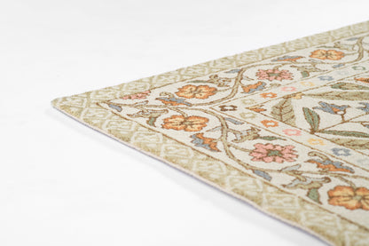 Cream floral area rug close-up: beige background, orange-pink flowers, blue accents, green leaves, decorative border.