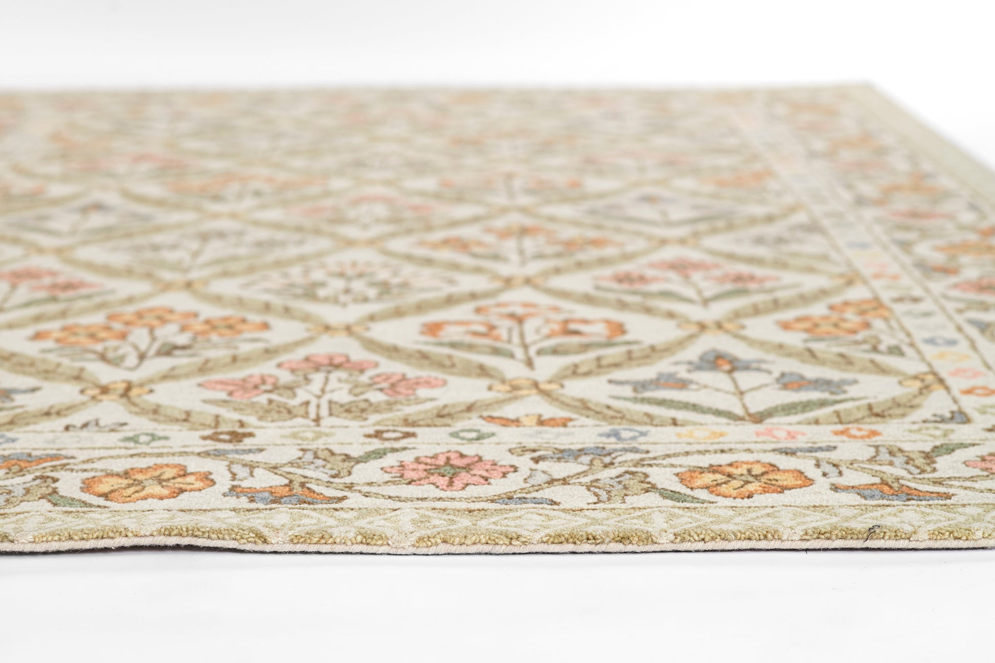 Cream oriental-style area rug with diamond lattice and floral motifs in sage green, peach, pink and blue.