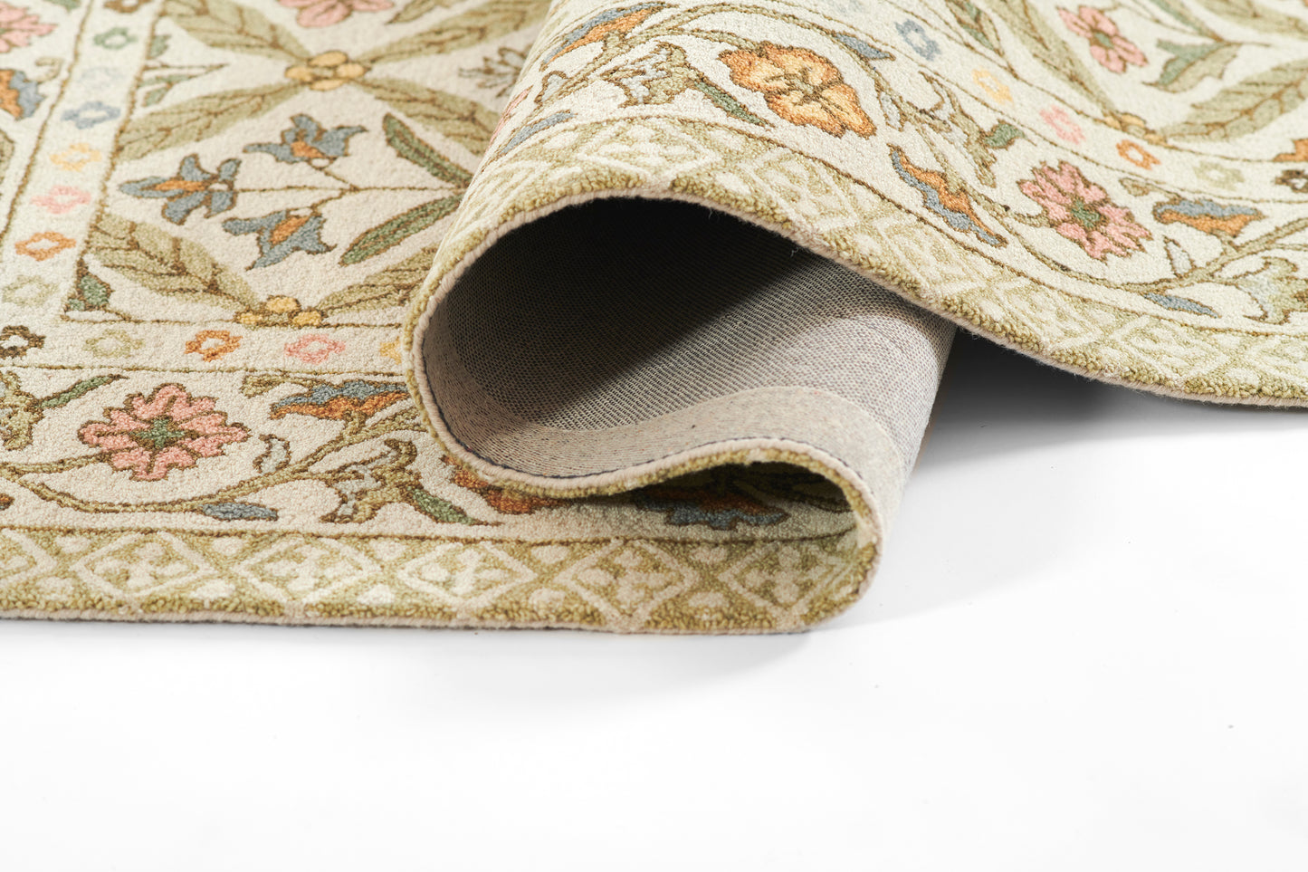 Soft cream Cotswold-style woven rug with pastel green, pink and blue floral pattern; rolled edge visible.