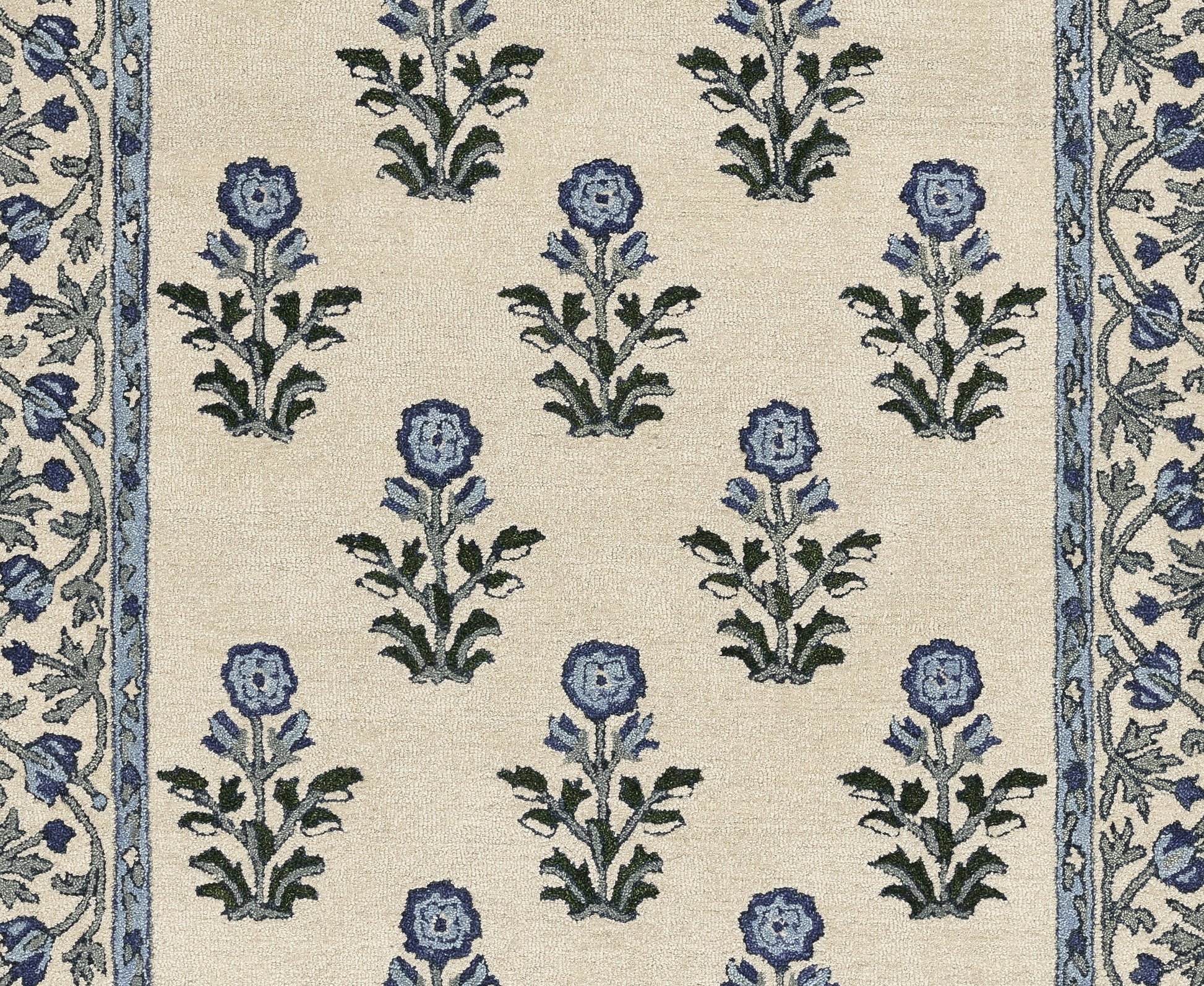 Beige fabric with repeating blue flowers and green leaves on cream, framed by narrow blue floral borders along sides.