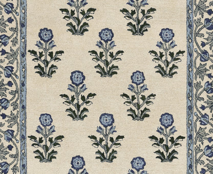 Beige fabric with repeating blue flowers and green leaves on cream, framed by narrow blue floral borders along sides.