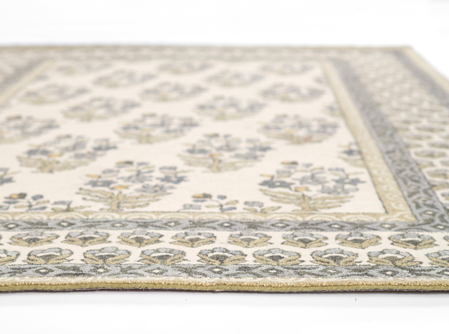 Cream area rug with blue-gray border and gold floral motifs; woven vintage-style living room rug.