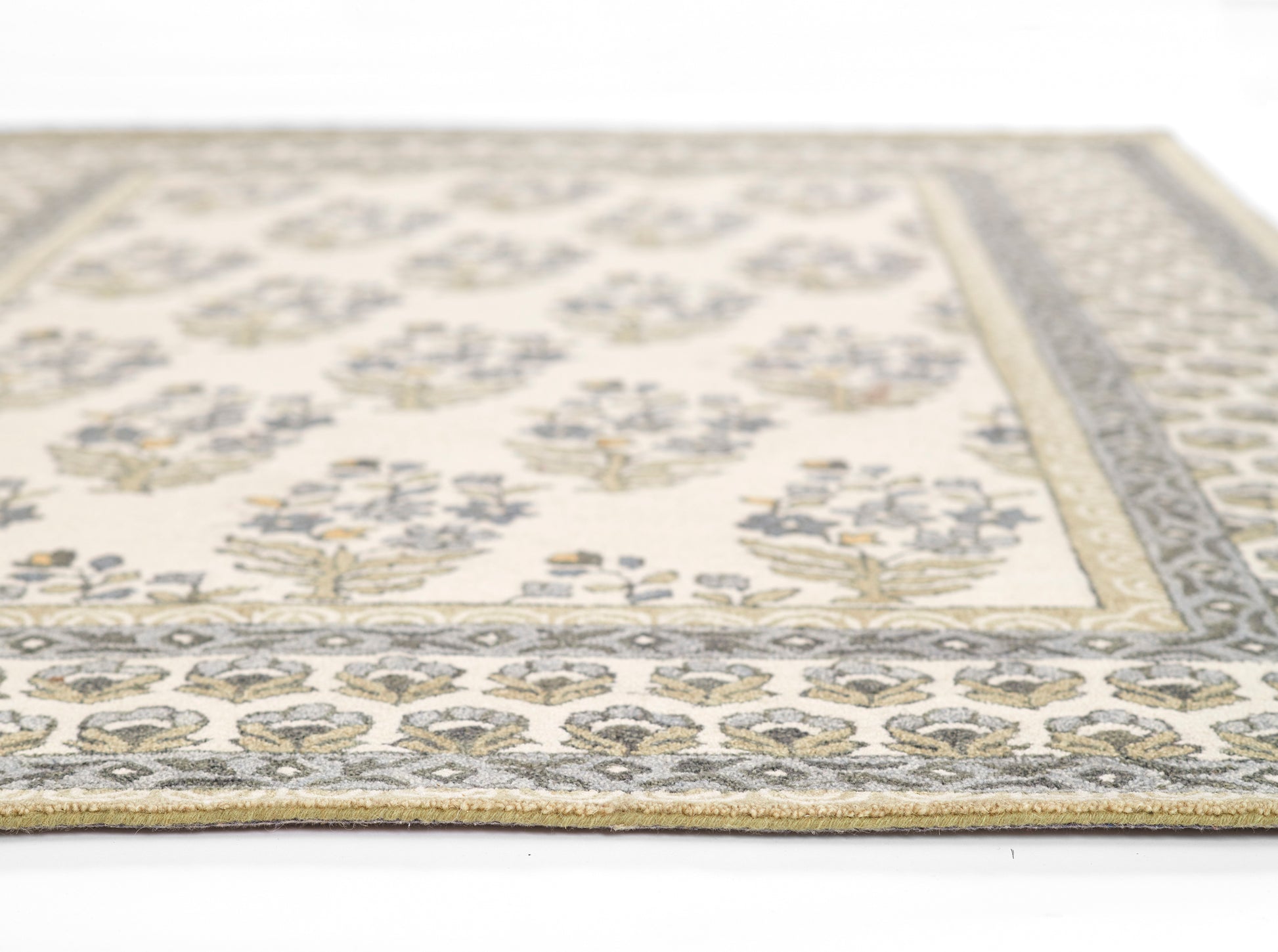 Cream area rug with blue-gray border and gold floral motifs; woven vintage-style living room rug.