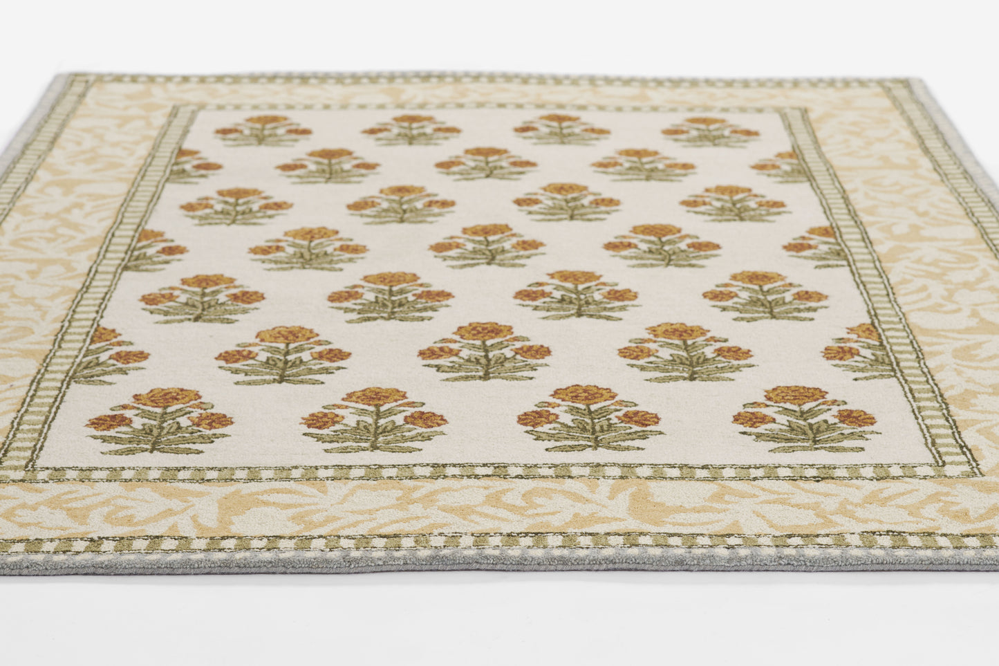 Rectangular cream runner rug with repeating orange-gold tree bouquets, green sprigs, and a pale beige decorative border.