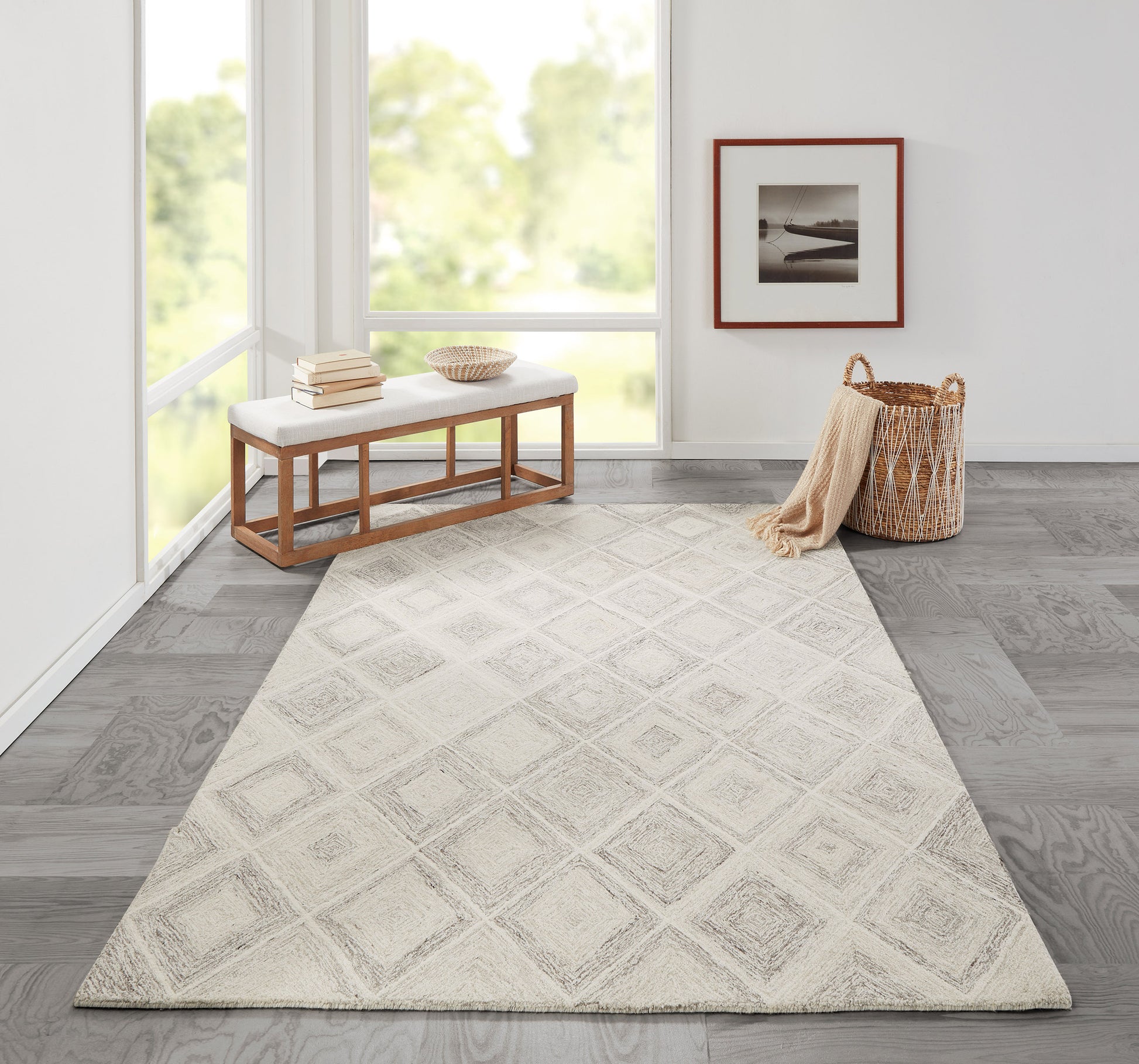 Beige diamond-pattern area rug in a bright sunlit living room with a wooden bench, woven basket, and framed art.