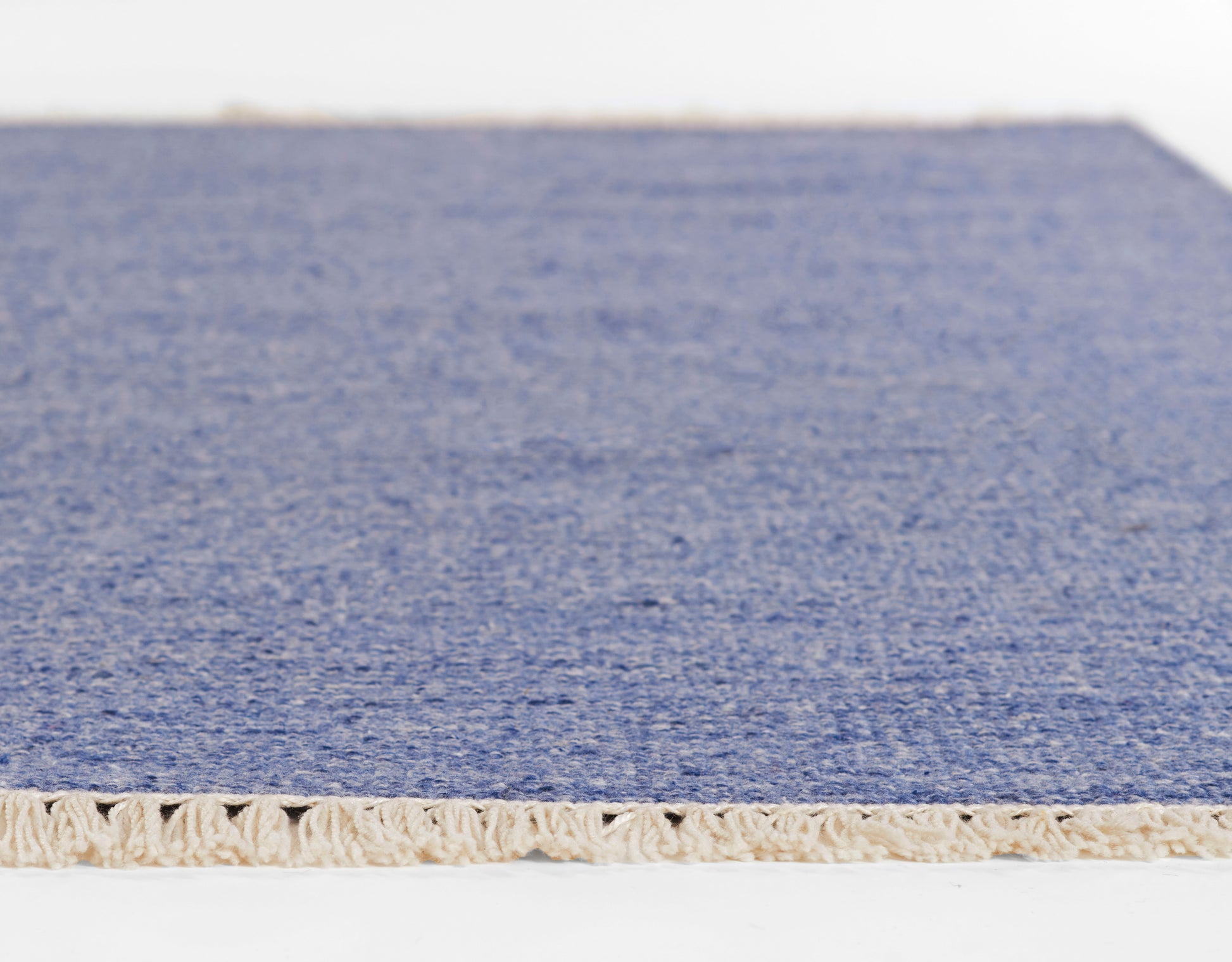 Blue flatweave runner with natural beige fringe; rectangular, modern coastal style for living areas, 2' x 8'.