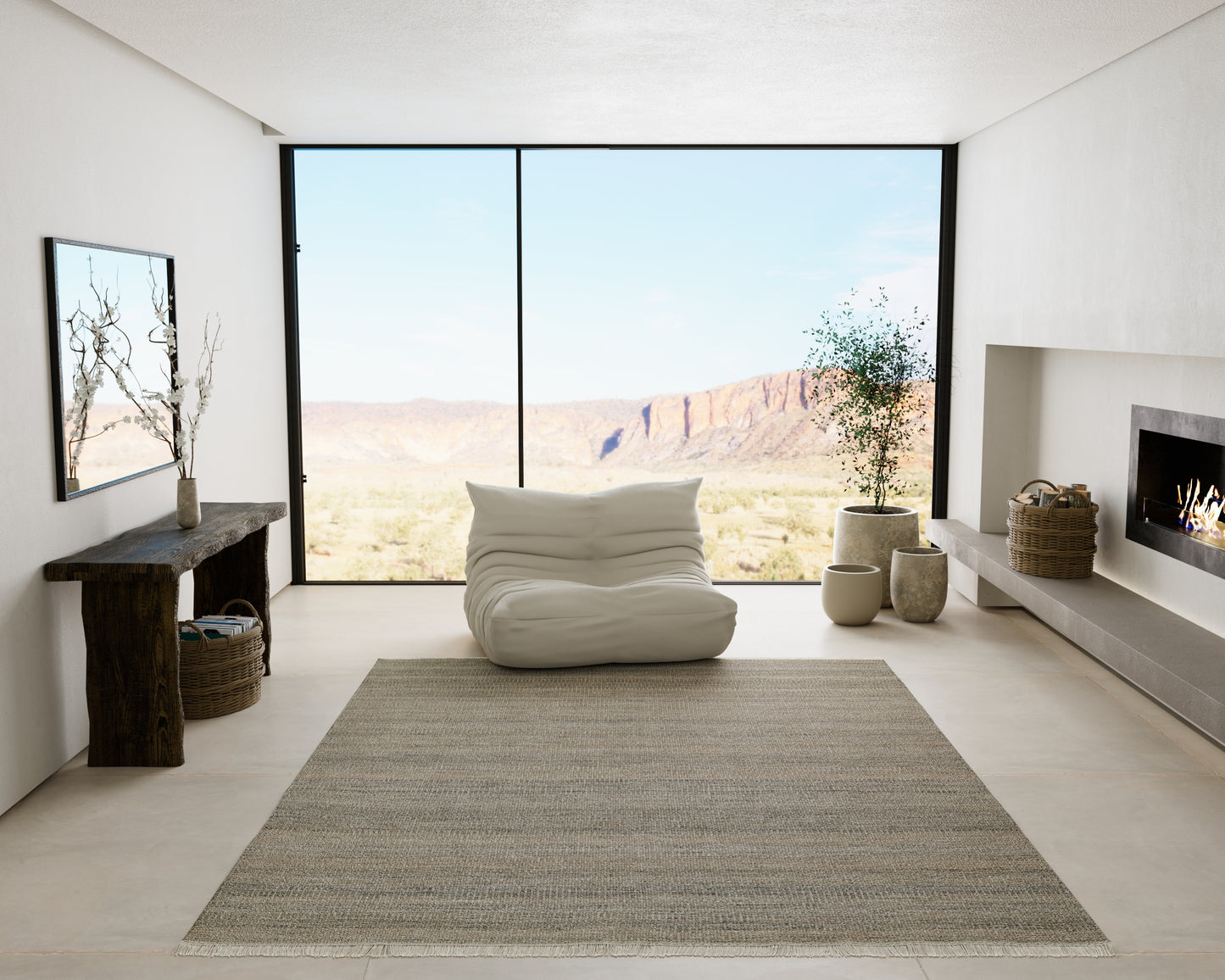 Gray textured area rug in a modern minimalist living room with a white lounge chair and desert mountain view.