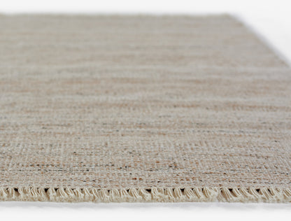 Natural beige woven jute rug with fringed edge and textured weave; rectangular area mat.