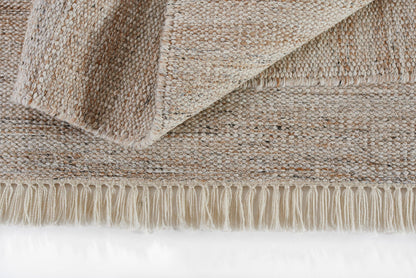 Natural beige rug with folded corner, textured flat weave and fringe trim.