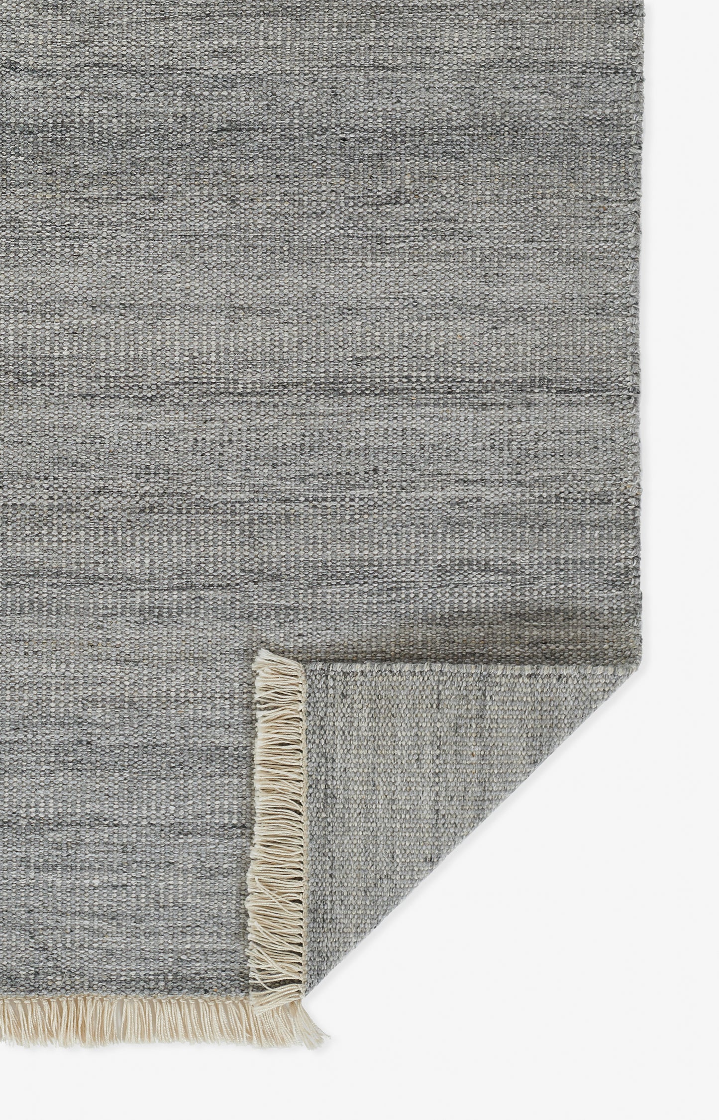 Gray flat-weave rug with beige fringe along edge; rectangular, modern minimalist style for living spaces.