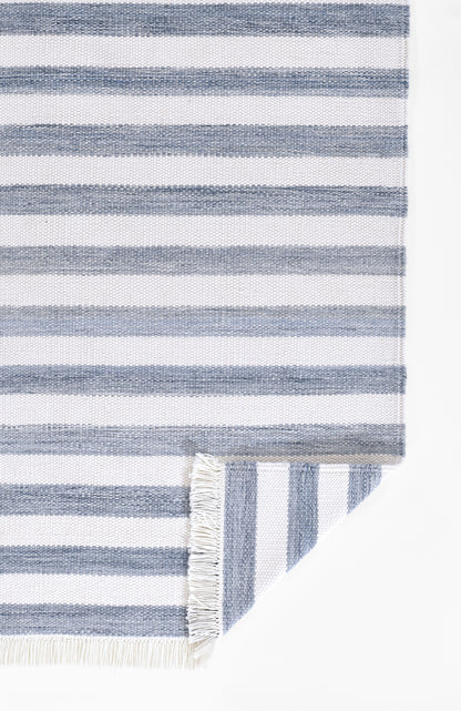 Blue & white striped rug with fringe edges, folded corner.
