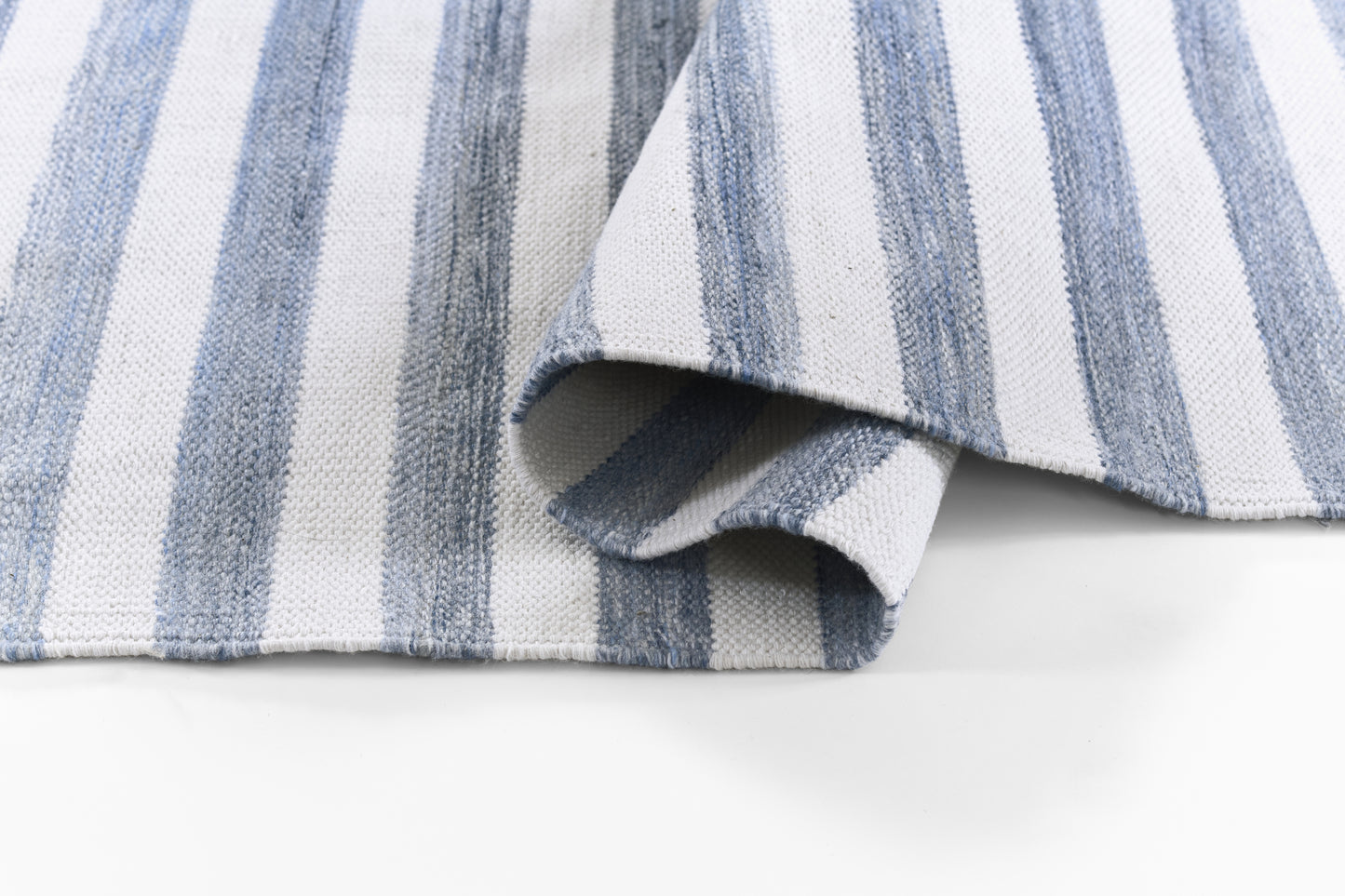 Blue & white striped woven cotton throw blanket with folded edge.
