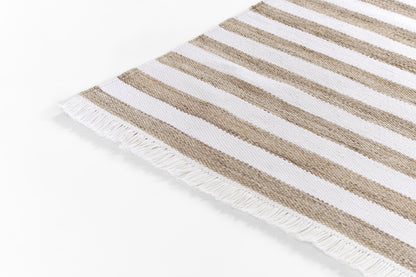 Beige and white striped woven rug with fringe along one edge.