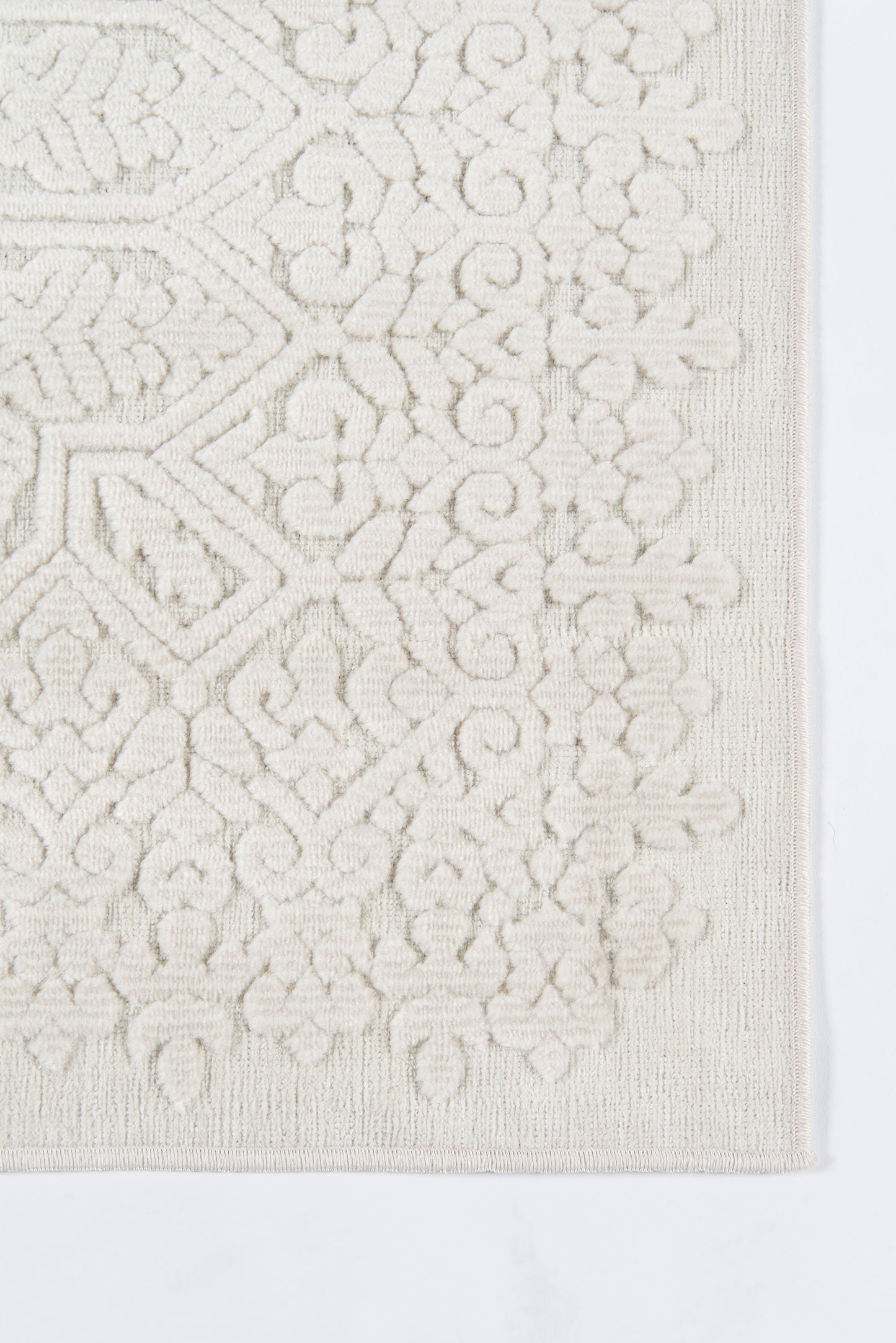 Cream ivory rug with raised geometric and floral motif; textured rectangle for living room decor.