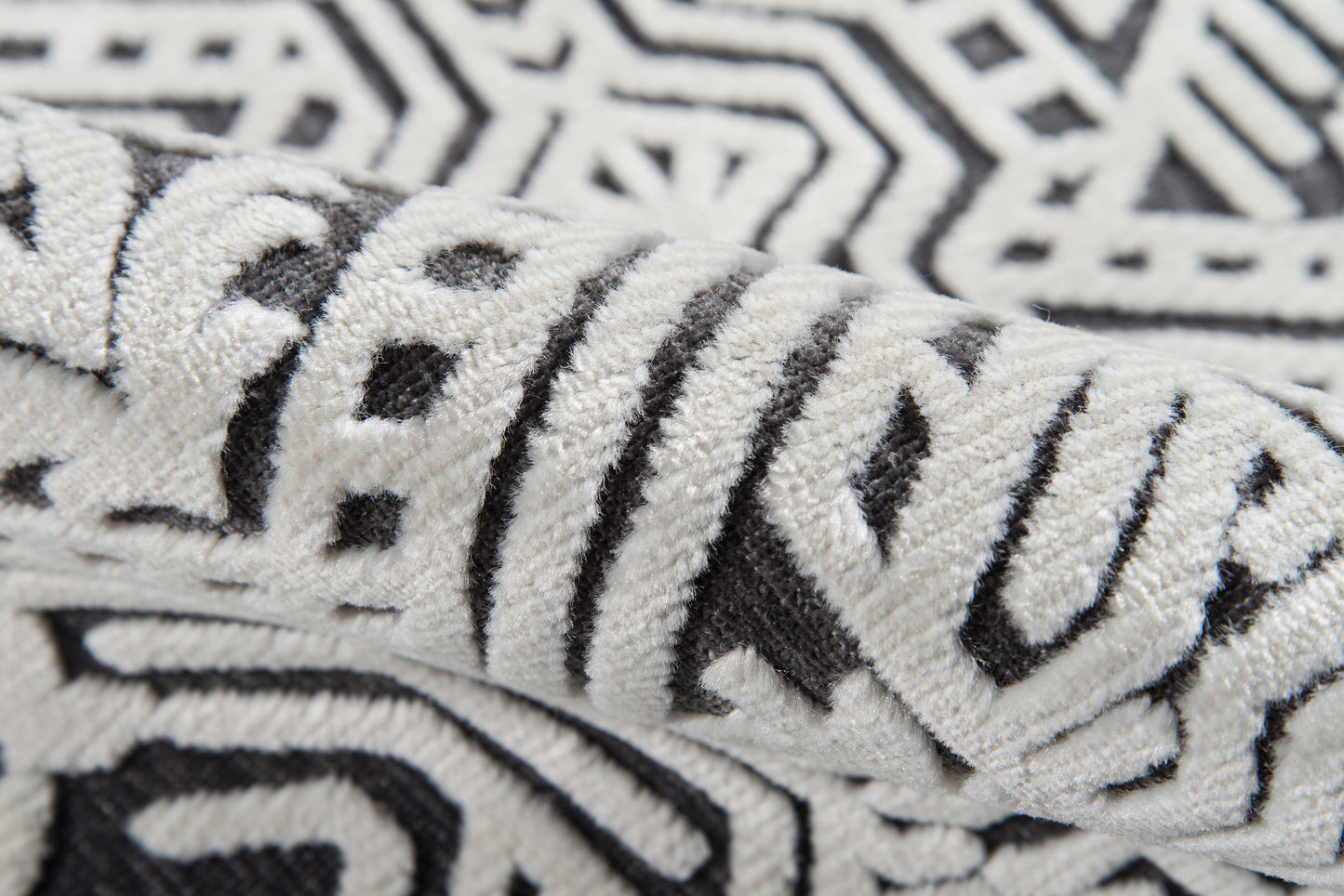 Close-up of plush black-and-white geometric towel with a bold zigzag pattern and soft terry texture.