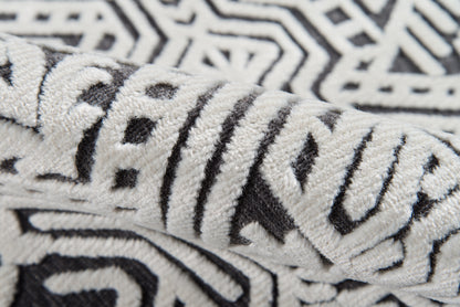 Close-up of plush black-and-white geometric towel with a bold zigzag pattern and soft terry texture.