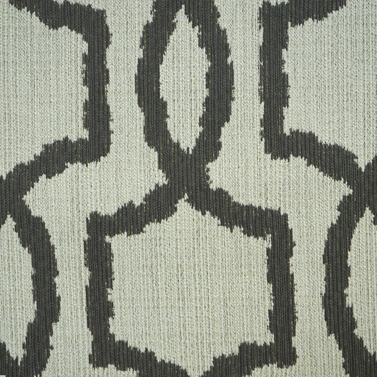 Beige fabric with a dark charcoal geometric lattice pattern; textured woven textile in a modern Scandinavian style.
