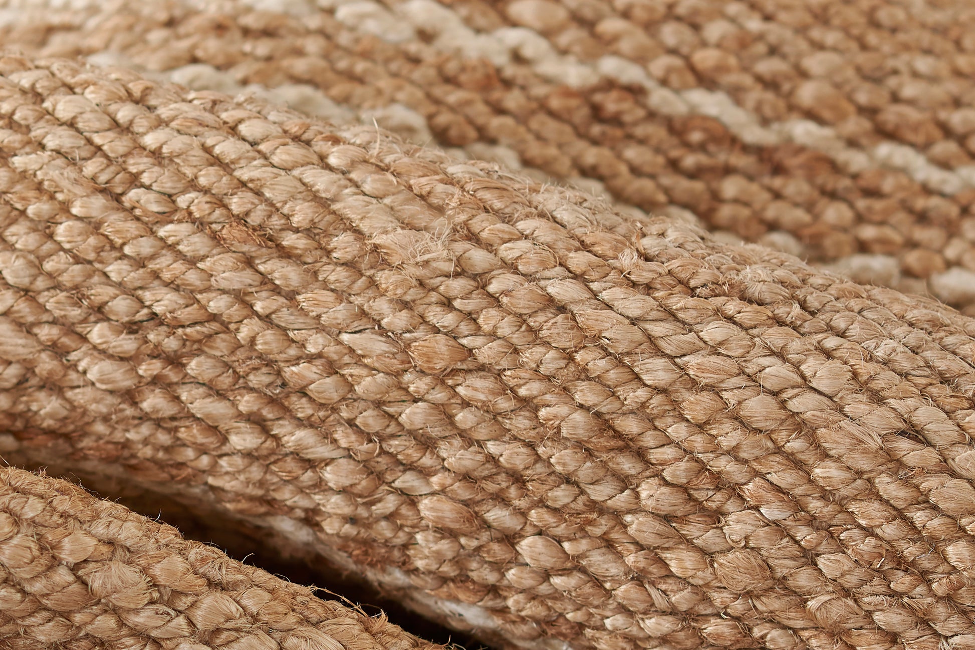 Beige natural rug close-up showing a looped-pile texture with a broken stripe design; measures 2' x 3'.