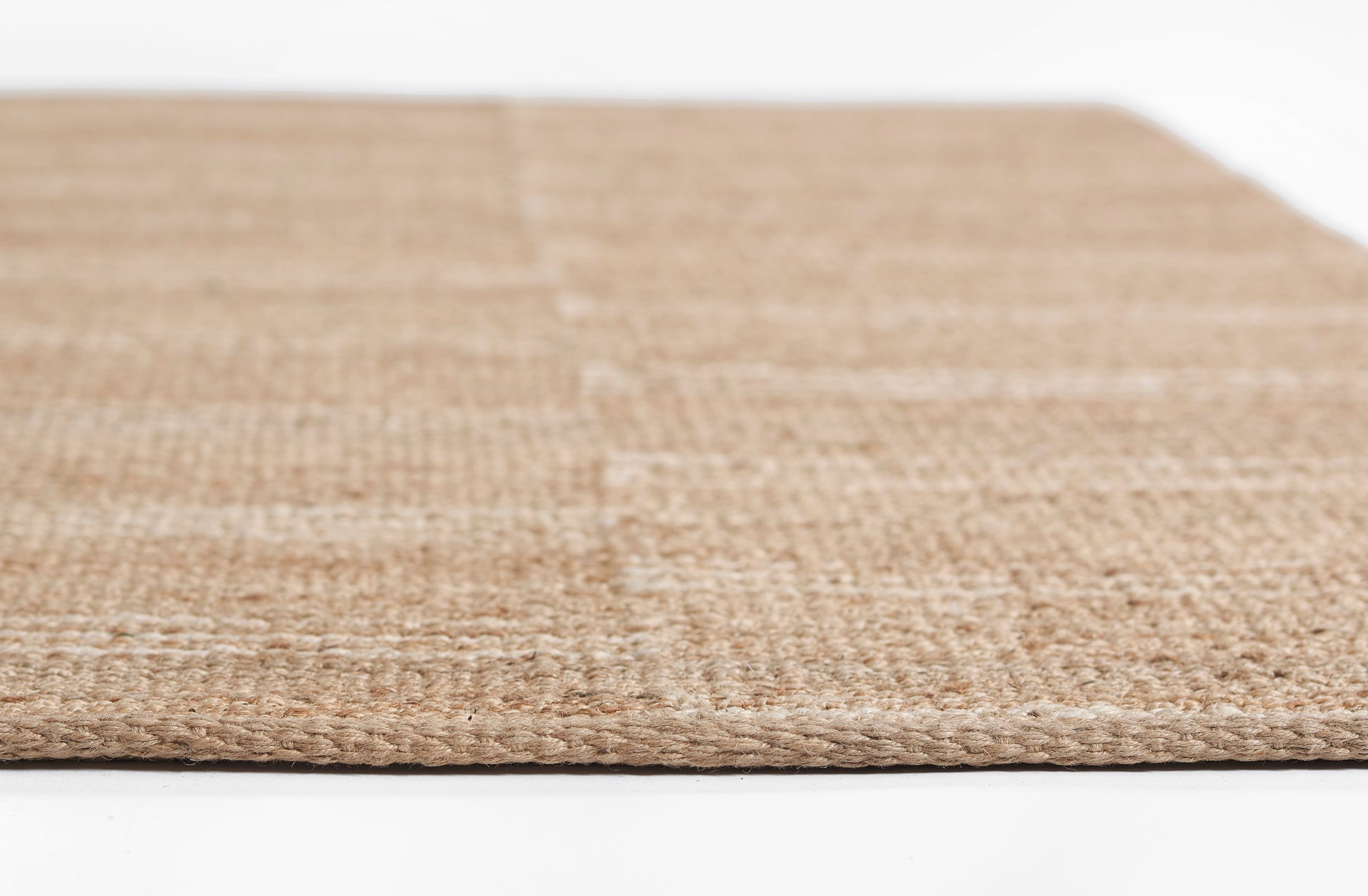 Natural beige woven jute rug, flat-weave texture, rectangular rug for living spaces.