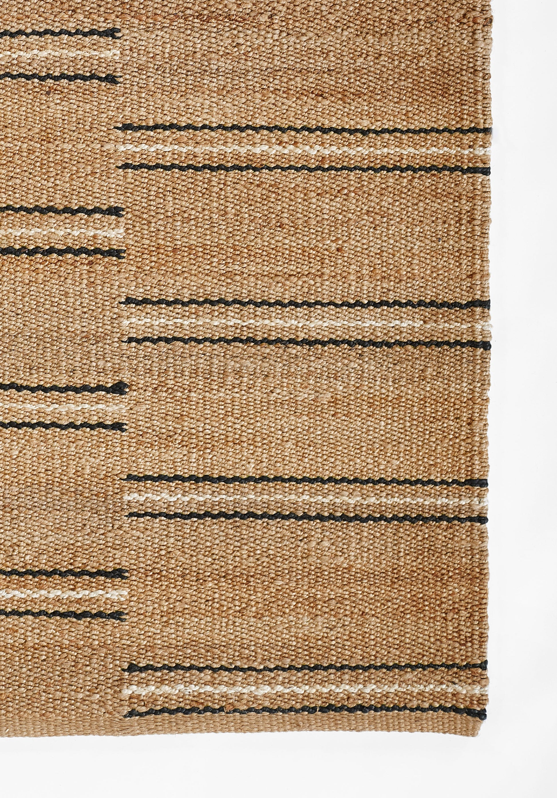 Natural tan woven jute rug with narrow black horizontal stripes; flat-weave, rustic coastal style.