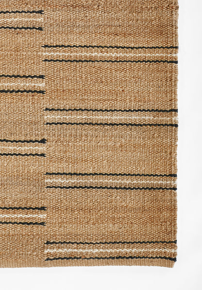 Natural tan woven jute rug with narrow black horizontal stripes; flat-weave, rustic coastal style.