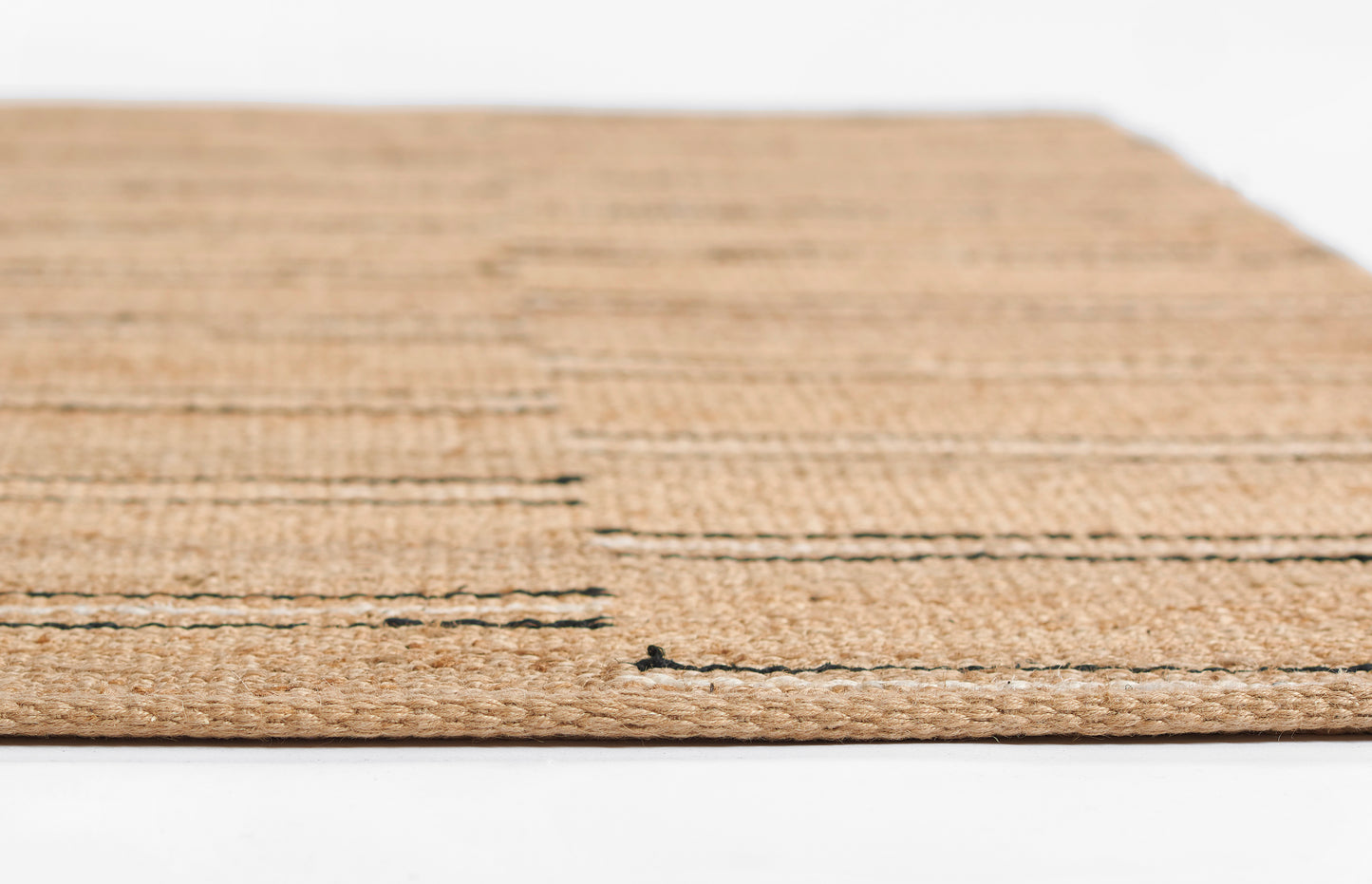 Rectangular natural jute rug with subtle dark horizontal stripes; rustic entryway rug.