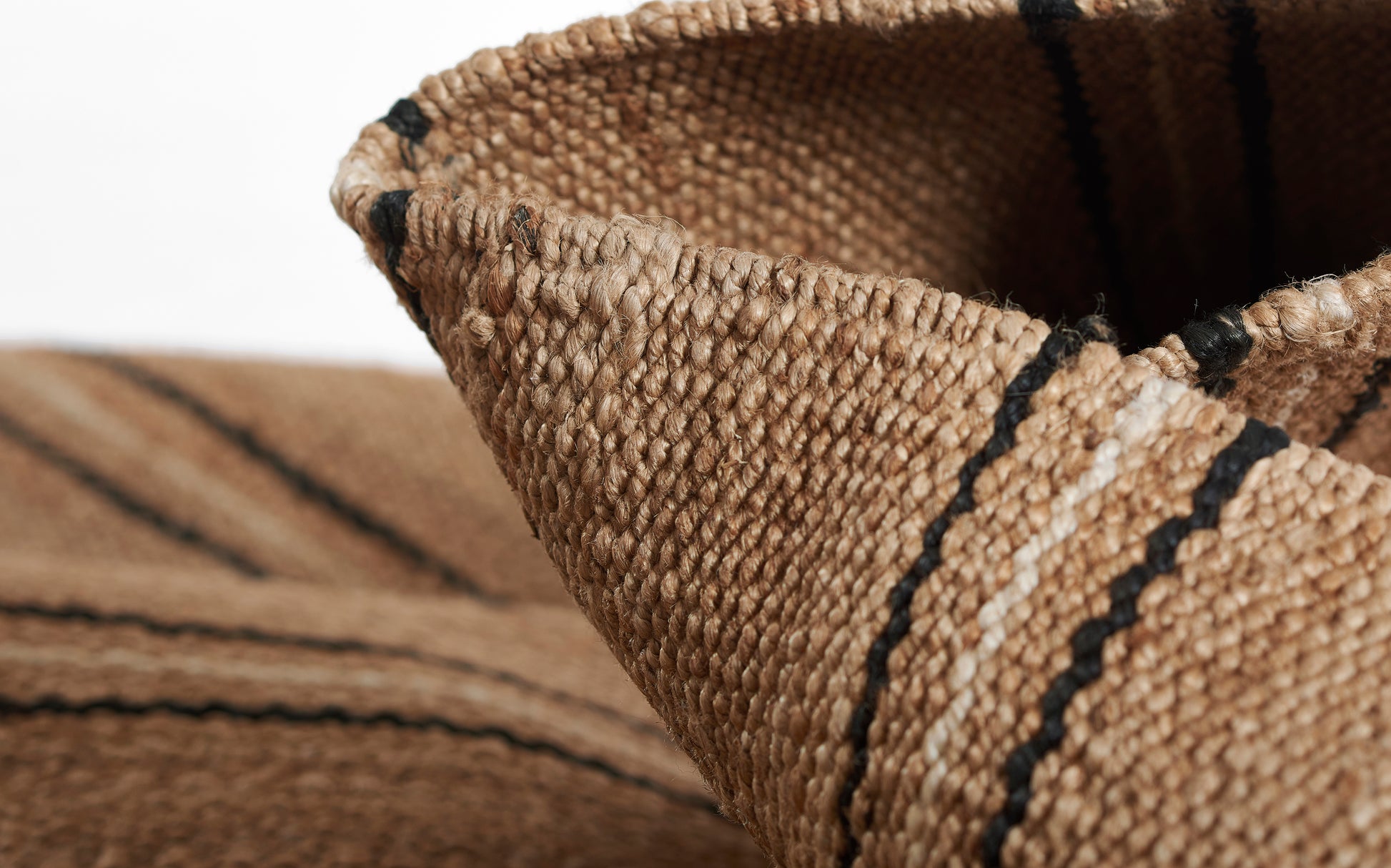 Natural-toned rug with a broken stripe pattern; measures 9' x 12'.