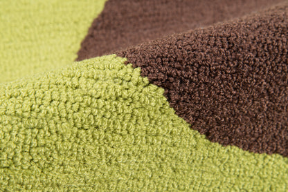 Close-up of lime green and chocolate brown color-block rug with looped texture.