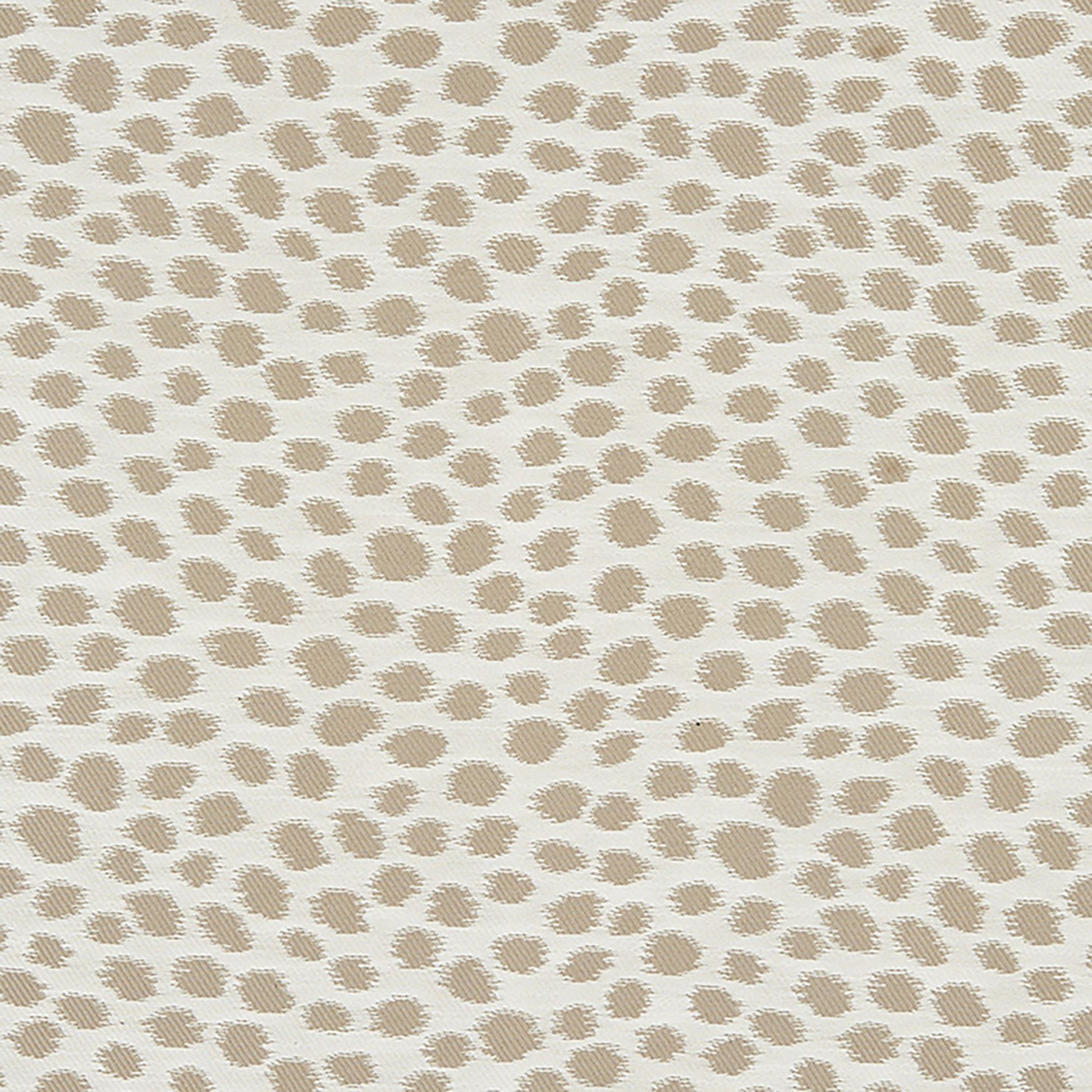 Beige Dalmatian-dot fabric on cream background; textured upholstery textile for cushions or drapes.