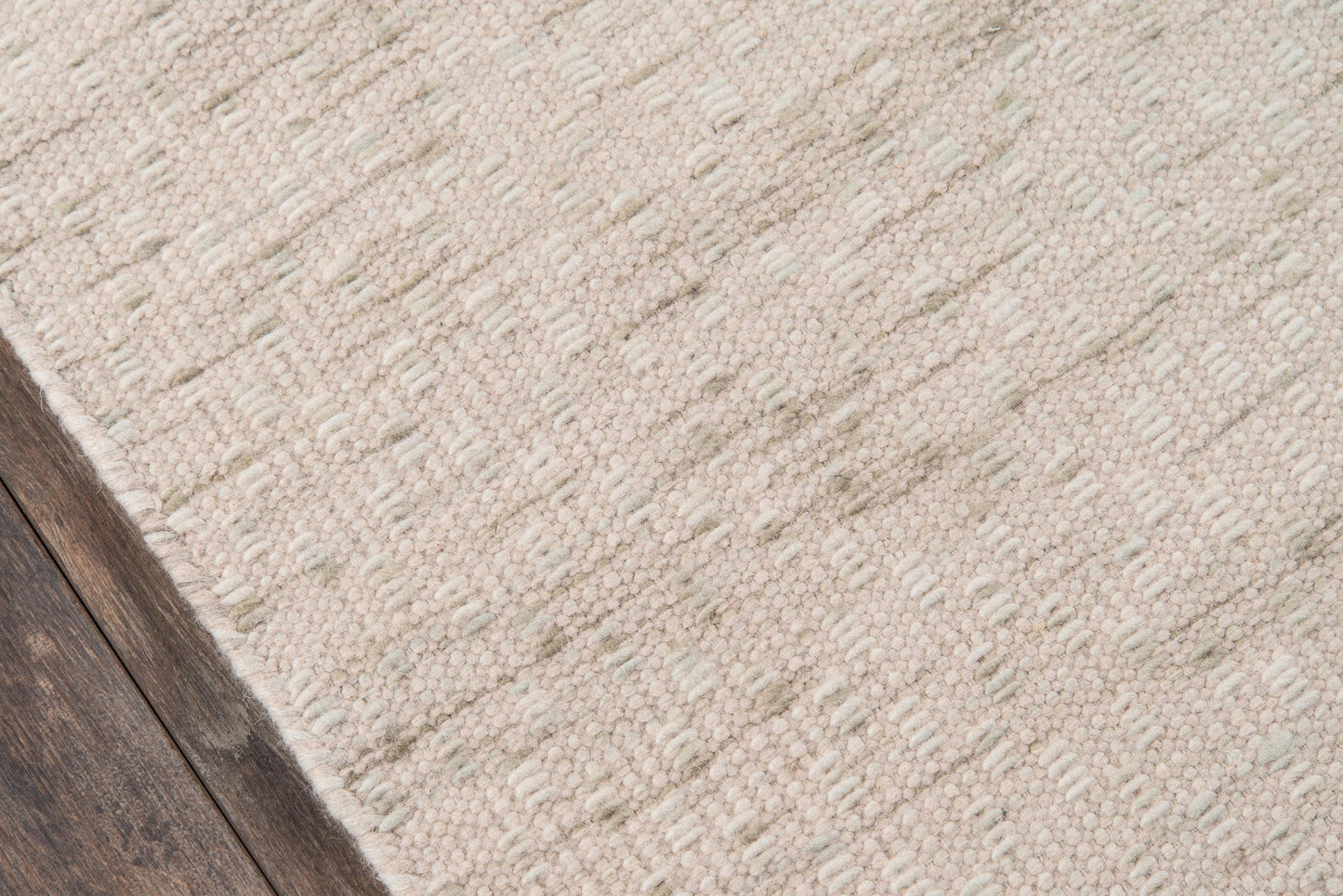 Beige textured area rug (5' x 8') with a subtle linear pattern on a dark wooden floor.