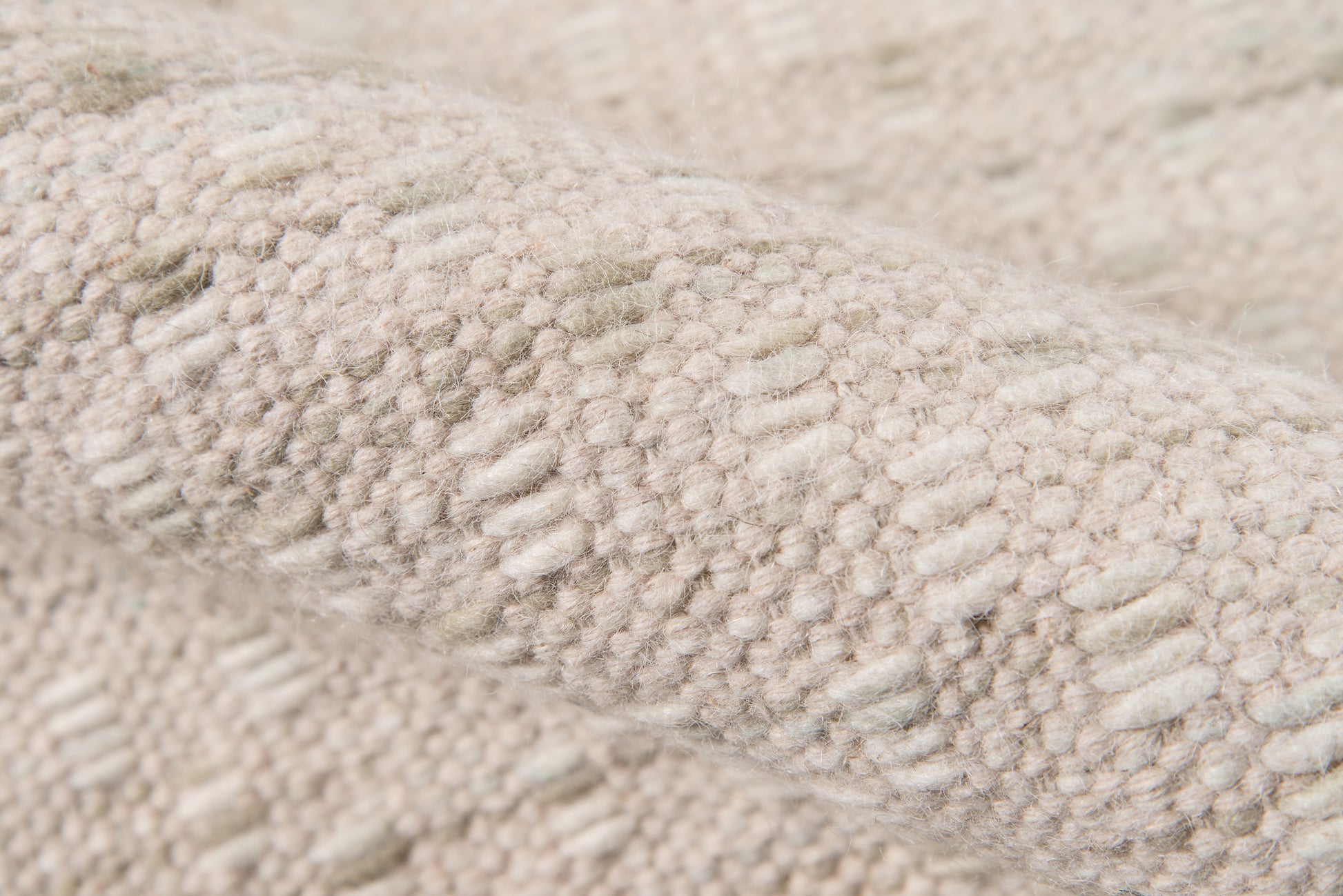 Beige boucle knit rug close-up with raised loop texture; soft, plush material.