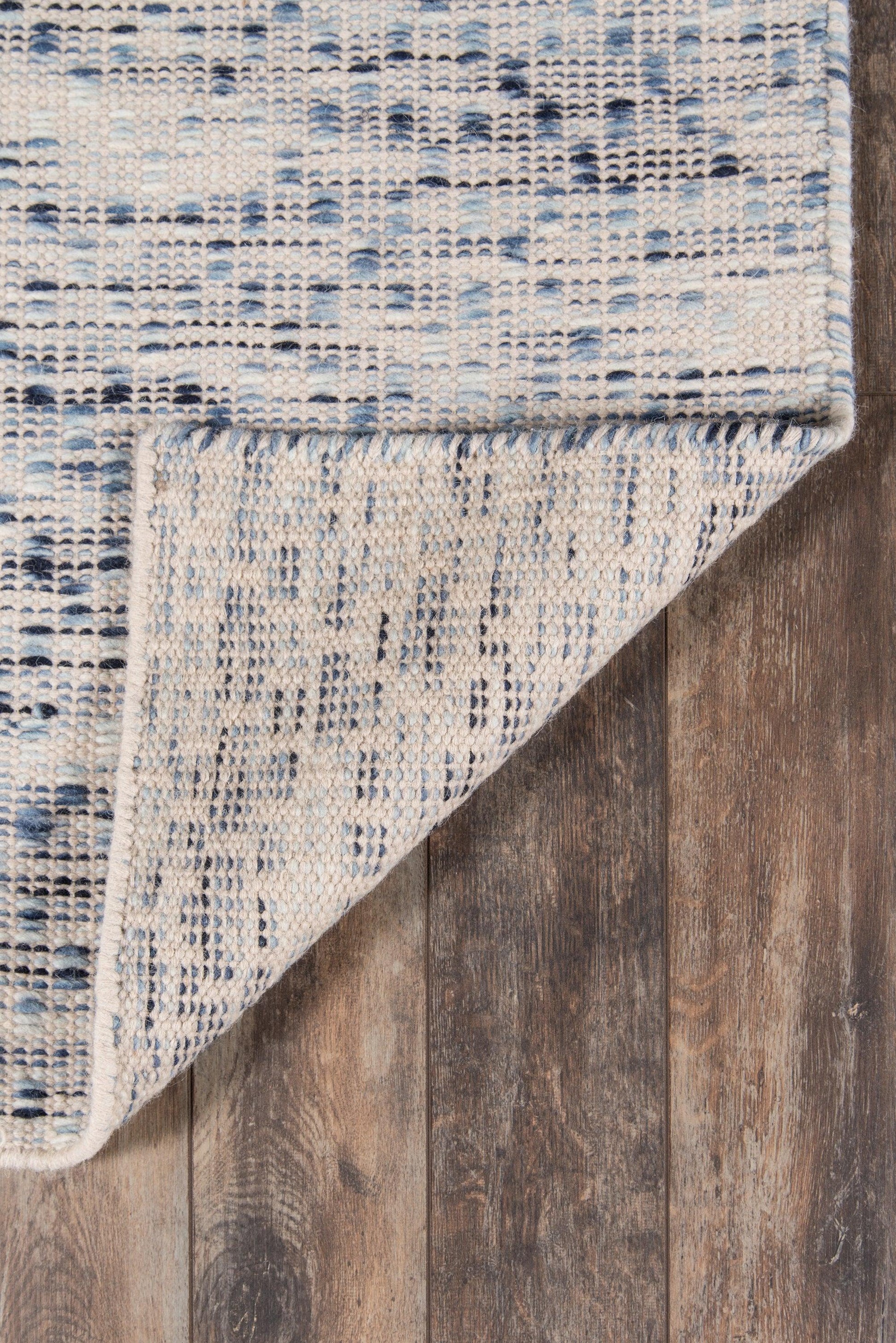 Blue & ivory woven rug with a speckled geometric pattern; low-pile, machine-made, suited for living room or hallway.