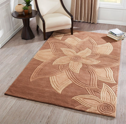 Warm brown area rug with a large beige floral motif in a cozy living room by a cream armchair and side table.