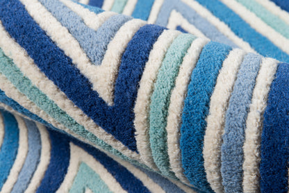 Blue, teal, and white striped rug, 4' x 6', rolled up.