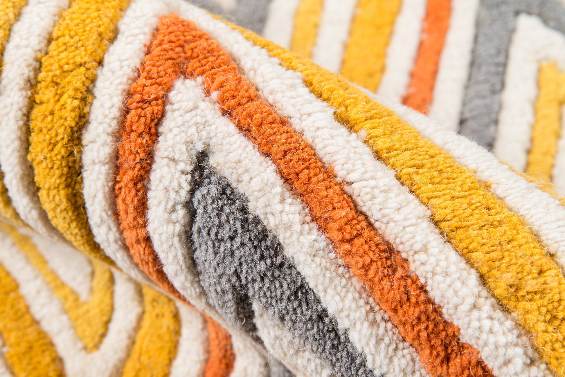 Shaggy striped rug in yellow, orange, white & gray tones; plush pile, decorative home accent.