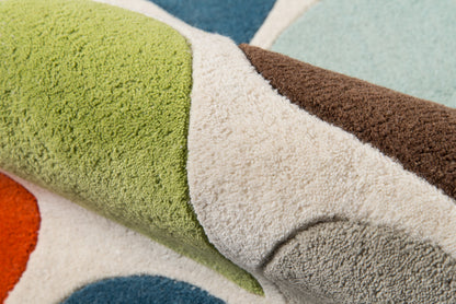 Multicolor geometric shag rug with lime green, brown, gray, teal and orange blocks; plush, thick pile.
