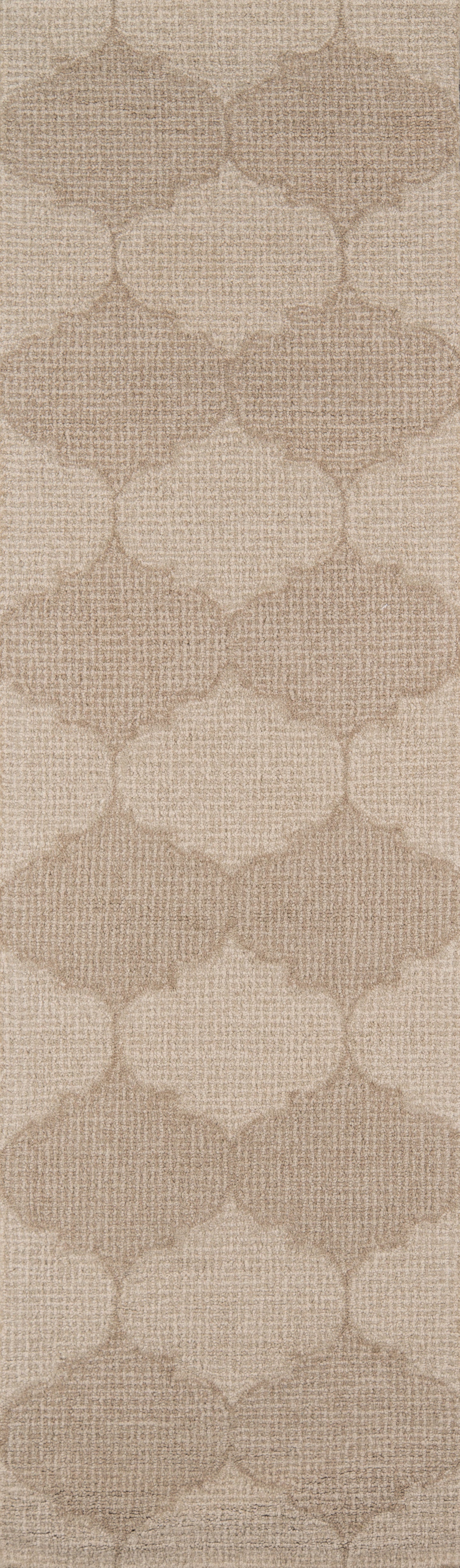 Beige woven-textured rug with a repeating trellis/quatrefoil pattern.