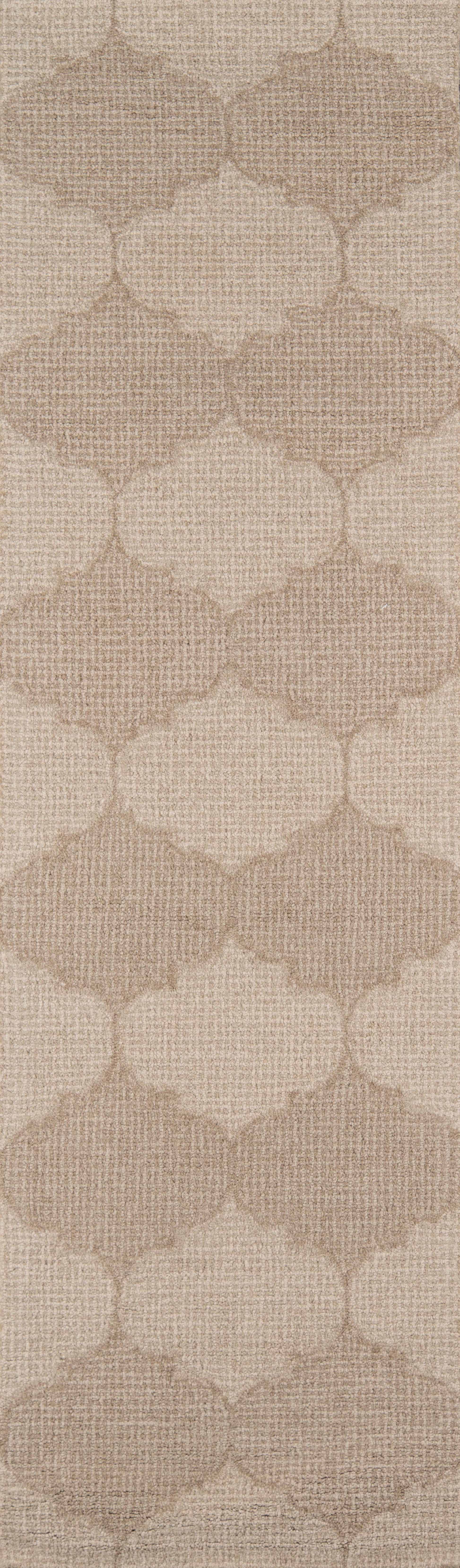Beige woven-textured rug with a repeating trellis/quatrefoil pattern.