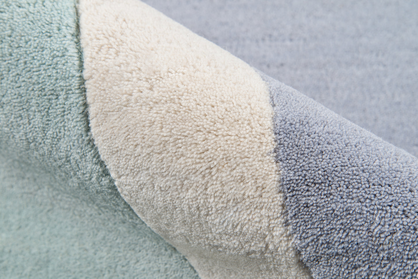Close-up of a color-block rug runner in teal, cream & blue with plush pile texture, 2' x 8'.