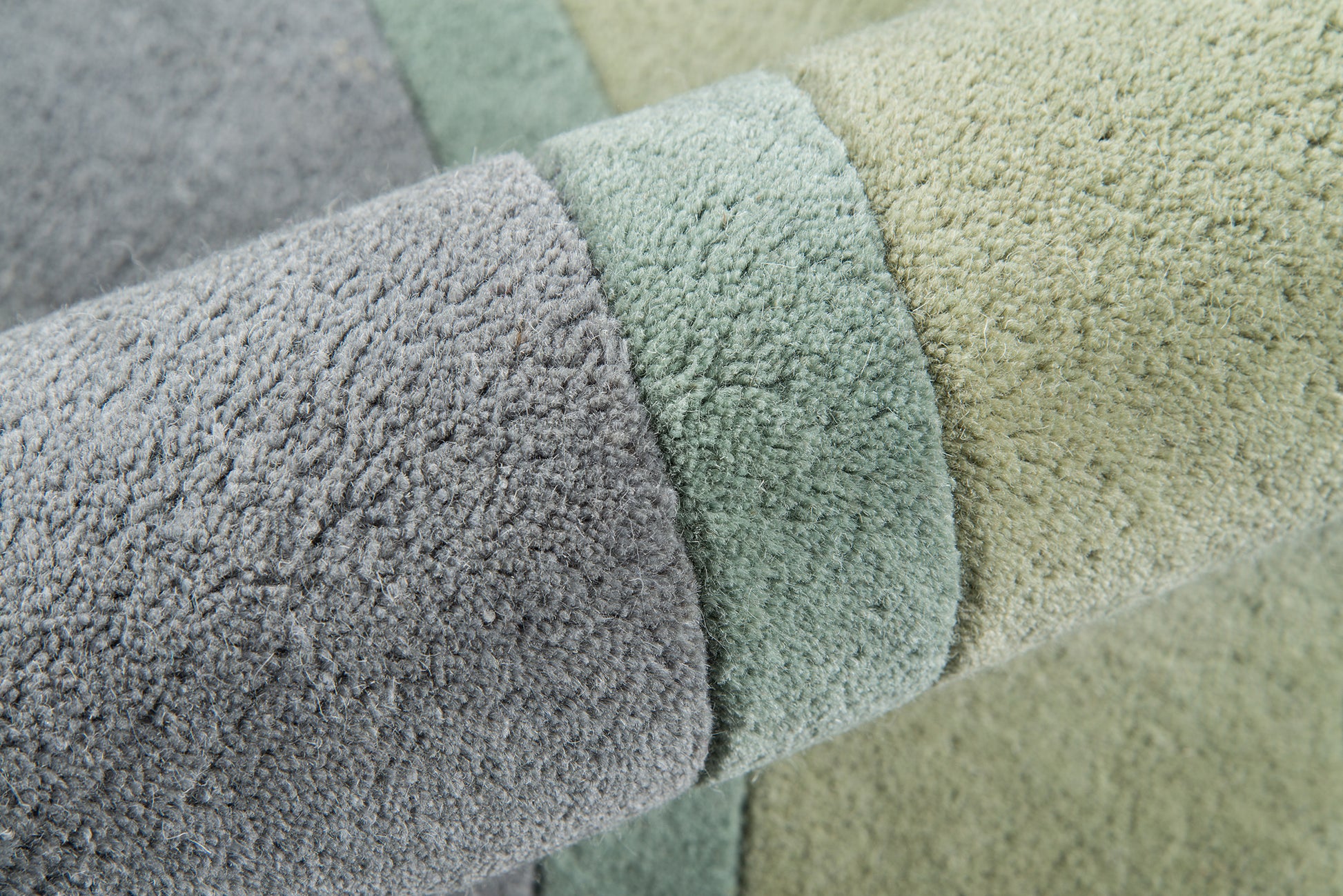 Soft plush rug runner in lavender, sage green, and pale beige with a looped texture, 2' x 8'.