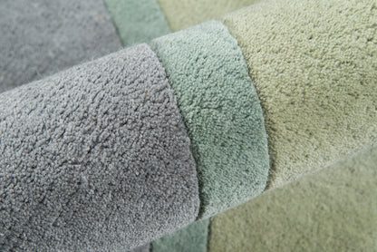 Pastel shaggy rug in lavender, mint, and pale yellow with soft textured pile.