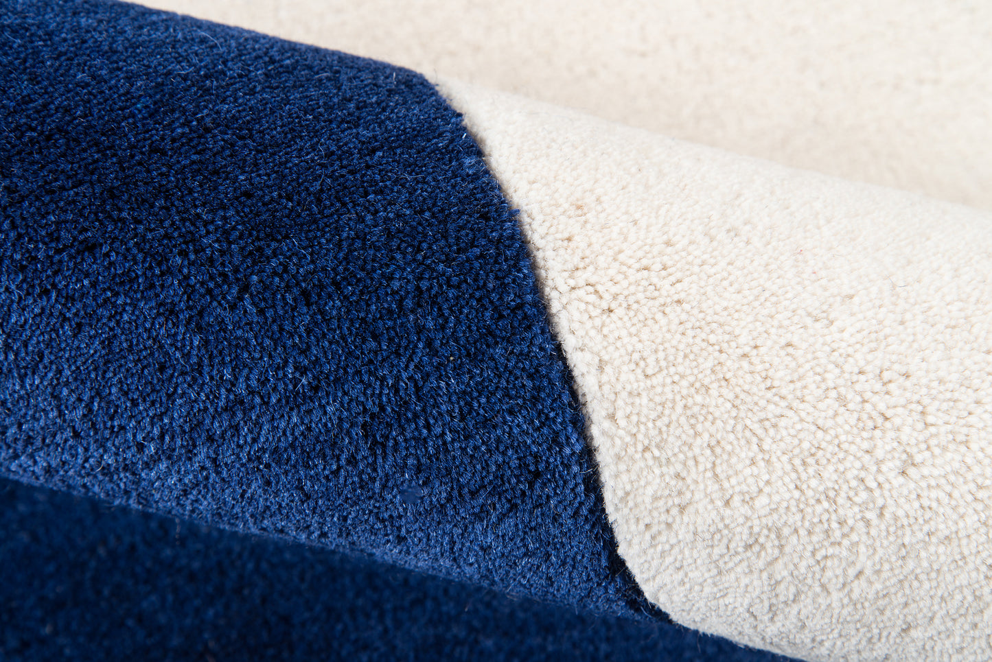 Two-tone navy blue and cream rug with looped pile texture.