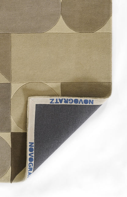 Beige-brown geometric rug with circles and rectangles; folded to reveal a dark navy underside.
